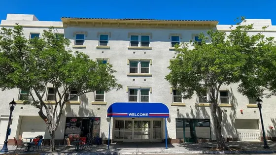 Large white building with a blue awning in front