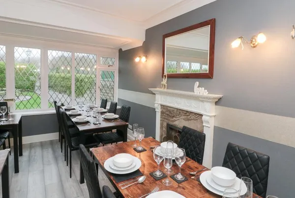 Seacrest Lodge formal dining room with tables set for eighteen guests