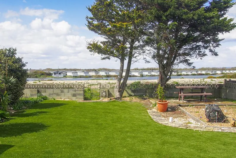 Seagull Cottage garden with mature trees and Pagham Harbour views