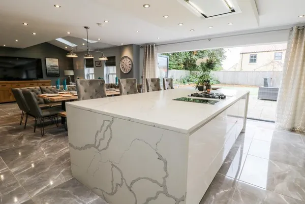 Seamer Manor House open-plan kitchen with marble island and bi-fold doors to garden