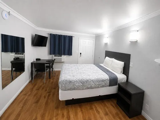 Bedroom with a bed and a desk in it