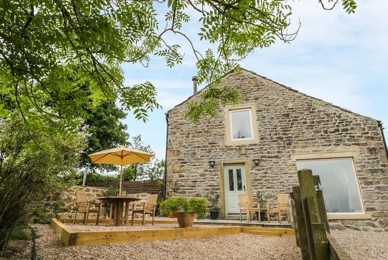 Shawclough Barn stone barn and patio in a countryside setting