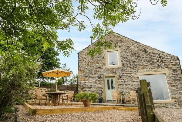 Shawclough Barn stone barn and patio in a countryside setting