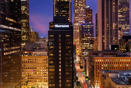 Tall building with a sign on it in a city