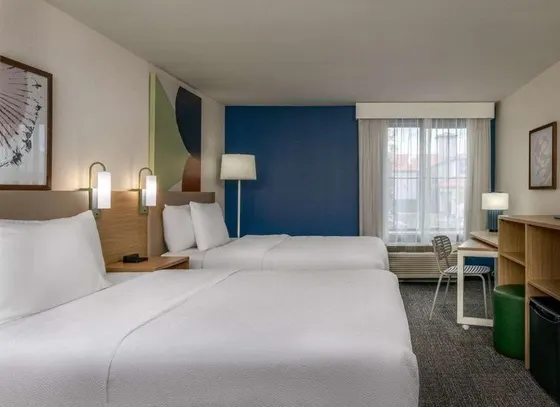 Two-bed room with a dark blue accent wall