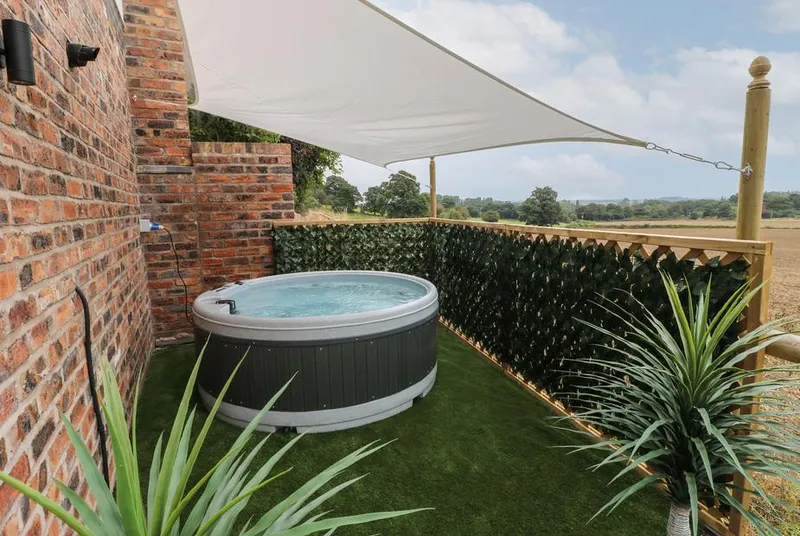 Slitting Mill Annex hot tub with countryside views and sail shade