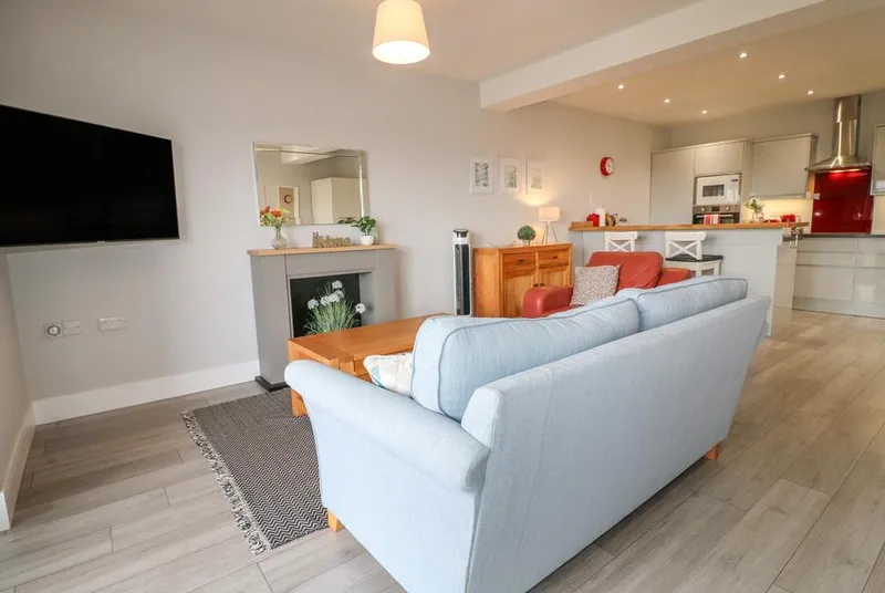 Slitting Mill Annex open-plan living room with fireplace and warm lighting