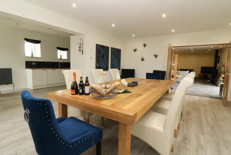 Snave Barn dining room with oak table and blue statement chairs