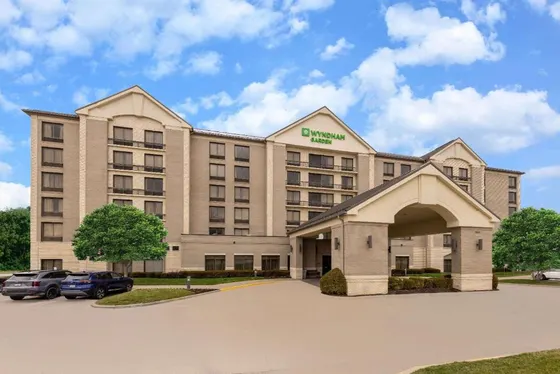 Hotel building with a car parked in a parking lot