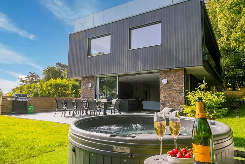 Sparrows Nest hot tub in lawned garden outside modern house