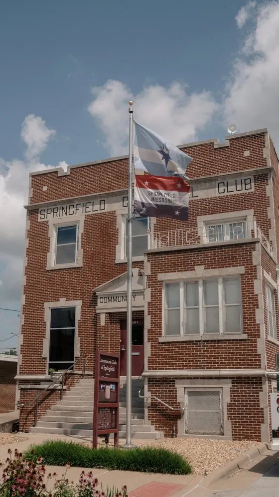 Springfield Commercial Club brick building with flags out front