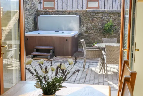 Stable View Cottage patio hot tub seen through open doors