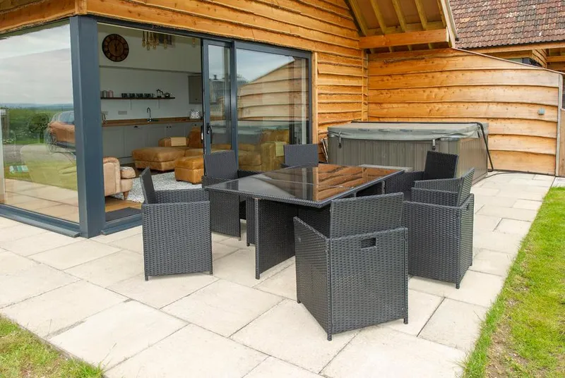 Starling Lodge patio with hot tub and bi-fold doors open to interior