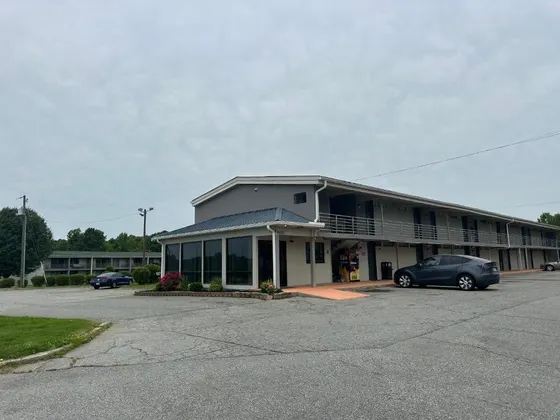 Building with a car parked in a parking lot