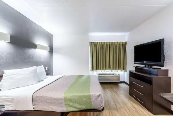 Room with a grey and lime striped bedspread