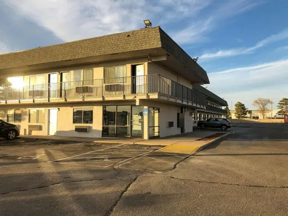 Building with a car parked in a parking lot