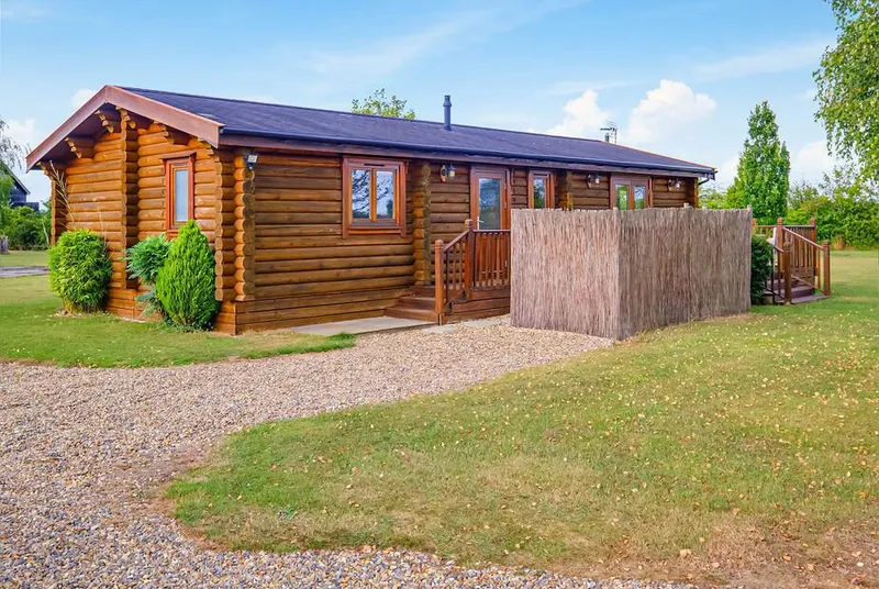 Sunrise VIP timber lodge exterior with screened hot tub deck