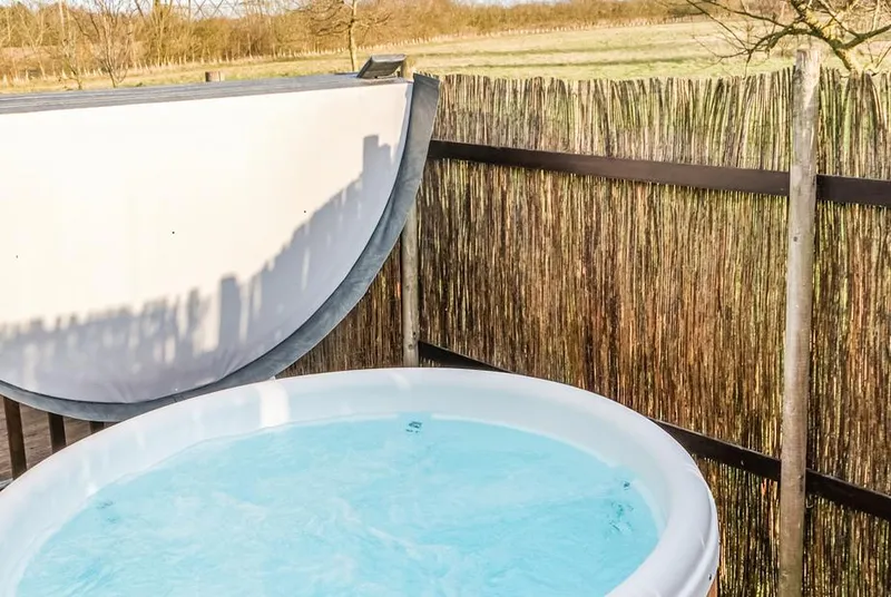 Sunrise VIP covered private hot tub behind a screen