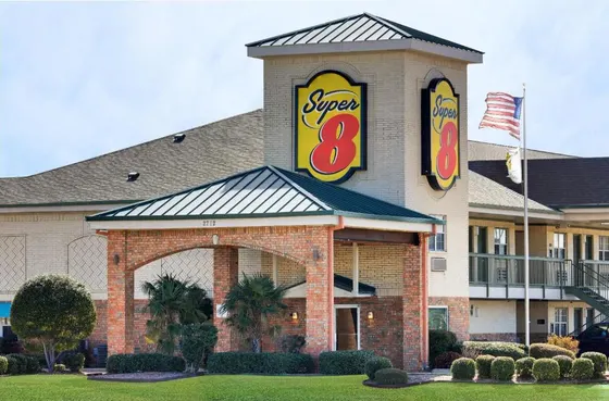 Brick hotel tower with a large yellow Super 8 sign