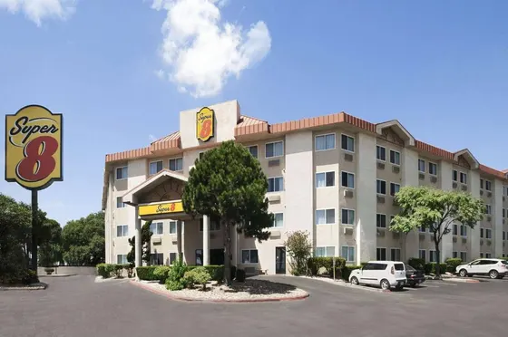 Beige hotel with a tall yellow Super 8 pole sign