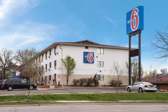 Three-story motel with a Motel 6 sign and parking lot