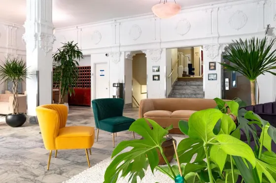 Lobby with yellow and green chairs and plants