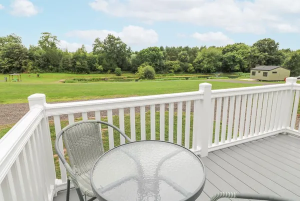 Swan Lodge deck outlook across the lawn and lake