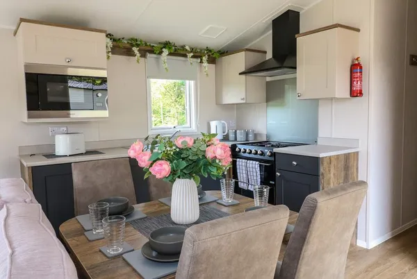 Swan Lodge kitchen and dining area with pink floral centrepiece