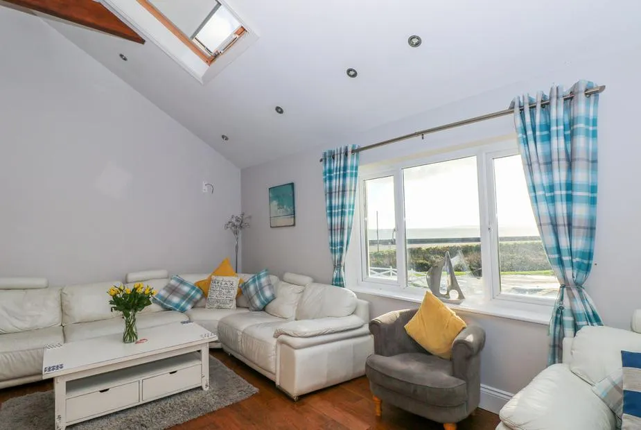 Swn y mor living room with vaulted ceiling, skylight and sea views