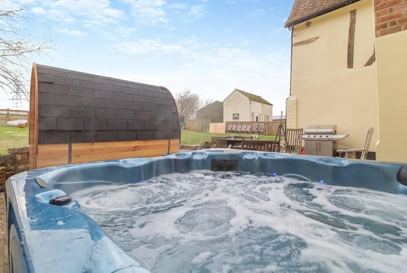 Sycamore Farmhouse outdoor hot tub with bubbling water on patio