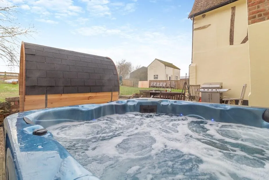 Sycamore Farmhouse outdoor hot tub with bubbling water on patio