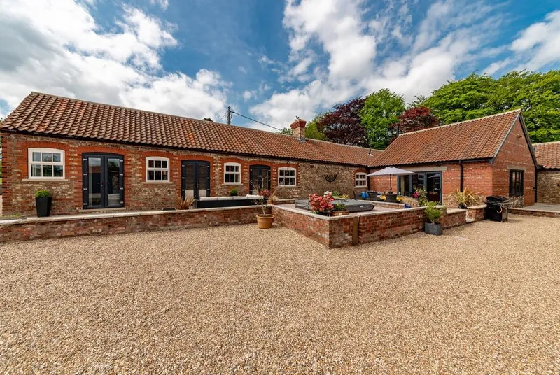 Sykes Lodge full barn conversion in daylight with blue sky