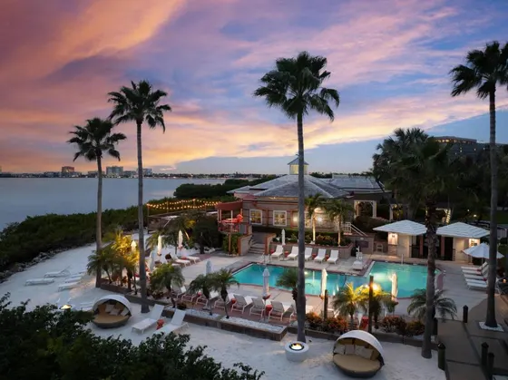 Aerial view of a resort with a pool and palm trees