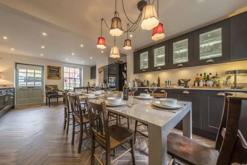 Tern Cottage kitchen-diner with herringbone floor and dark cabinets
