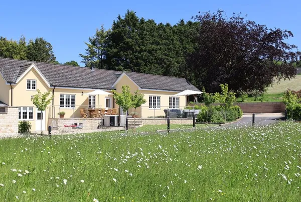The Anchorage from wildflower meadow with rolling Wiltshire hills
