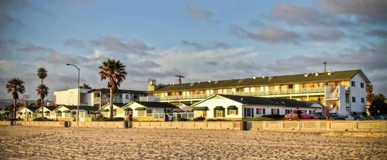 Group of houses on the beach next to a building