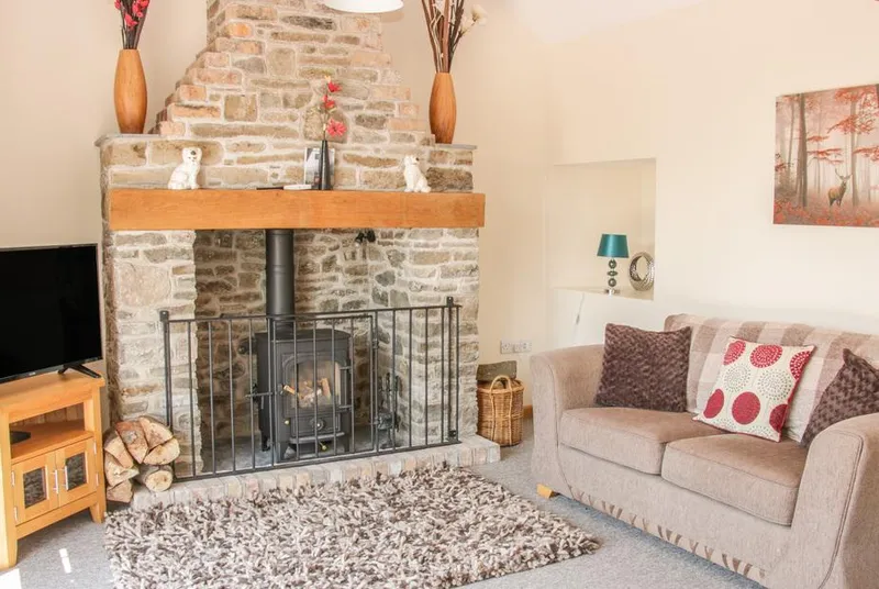 The Boundary Annex sofa by the stone fireplace