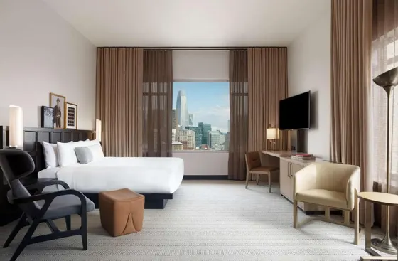 Hotel room with a bed and a large window