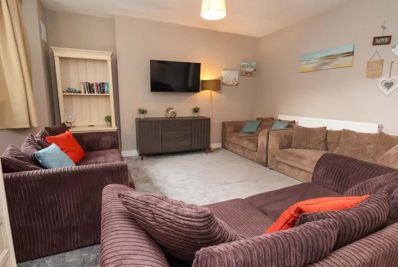 The Corner House living room with corduroy sofas and coastal beach decor