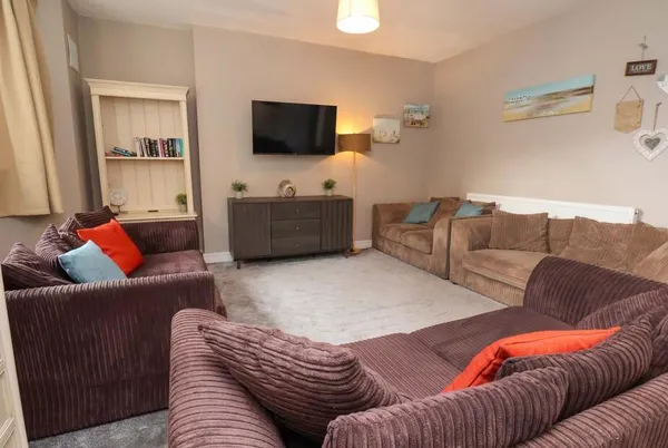 The Corner House living room with corduroy sofas and coastal beach decor