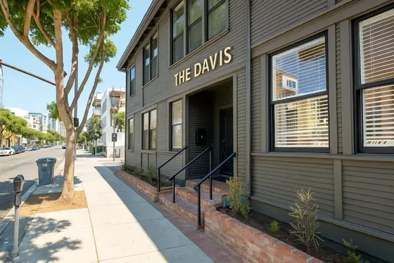Building with a sign that reads the dayls