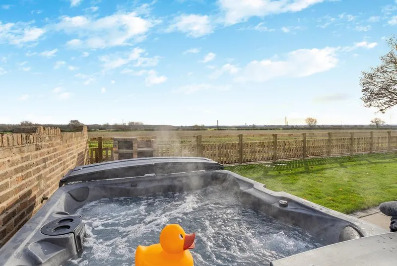 The Farm House bubbling hot tub with open field views