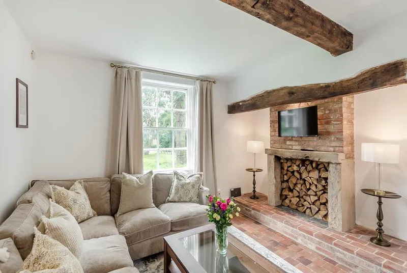 The Farmhouse lounge with brick fireplace and exposed beams