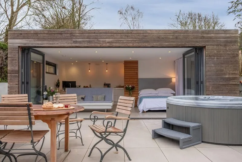 The Garden Room patio with hot tub and open bi-fold doors