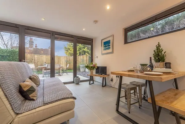 The Garden Room living area looking out through bi-fold doors