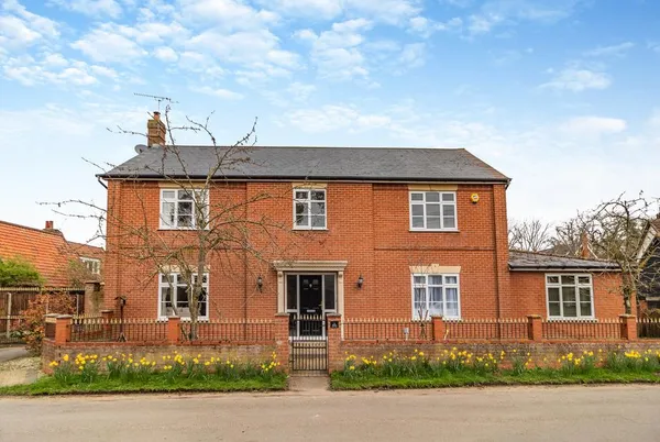 The Great Escape red brick house exterior from the road