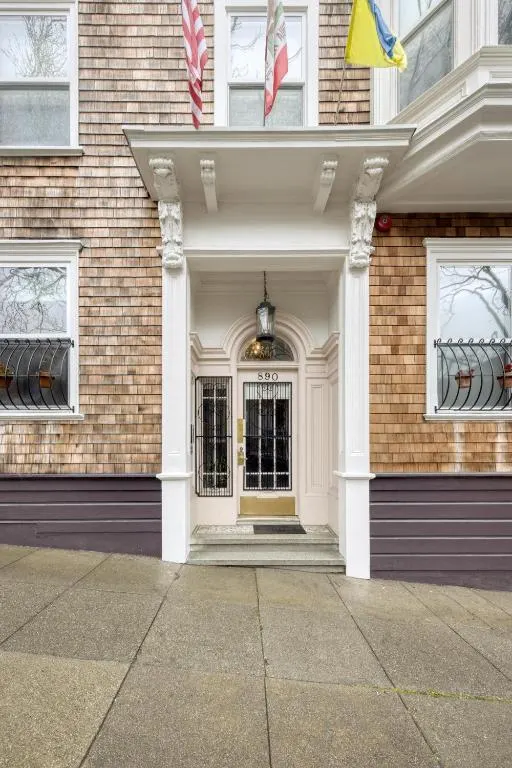 White front door of a brick building