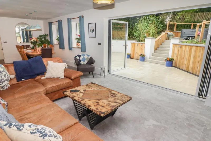 The Grove open-plan living room opening onto the terrace and raised spa deck