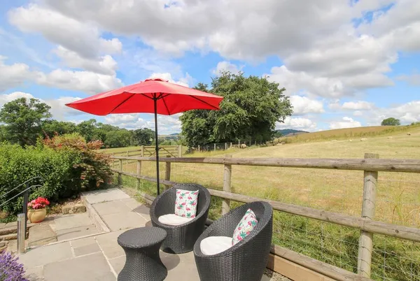 The Hay Loft terrace seating with countryside beyond