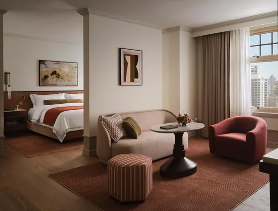Hotel room with a bed and a couch and a table